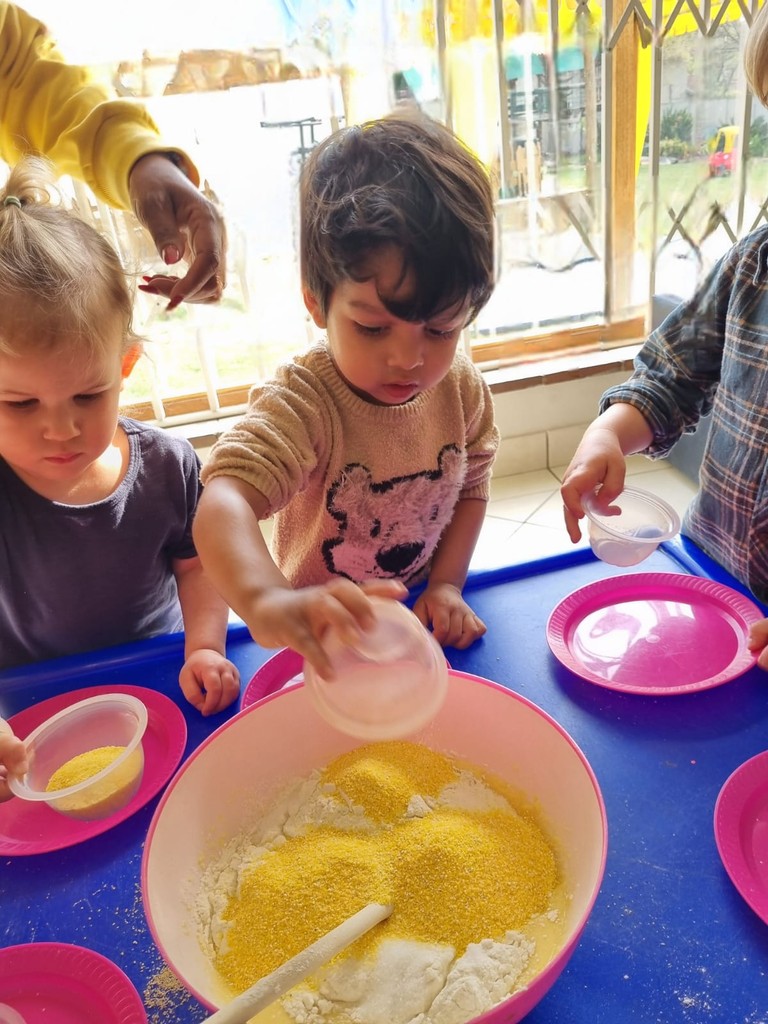 Children mixing ingredients in bowls during a hands-on baking activity