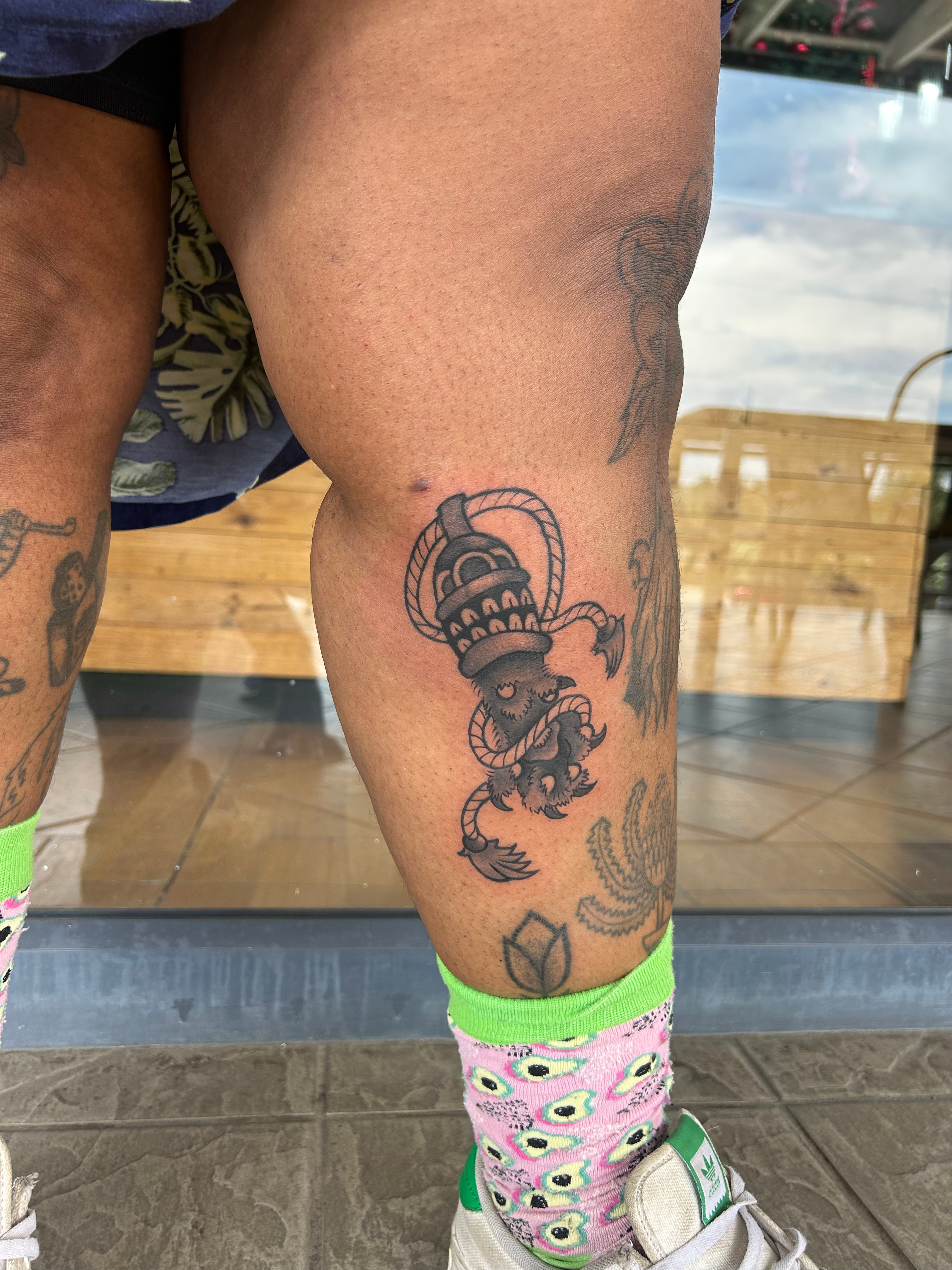 Black-and-grey traditional lantern tattoo on the calf by Dwane