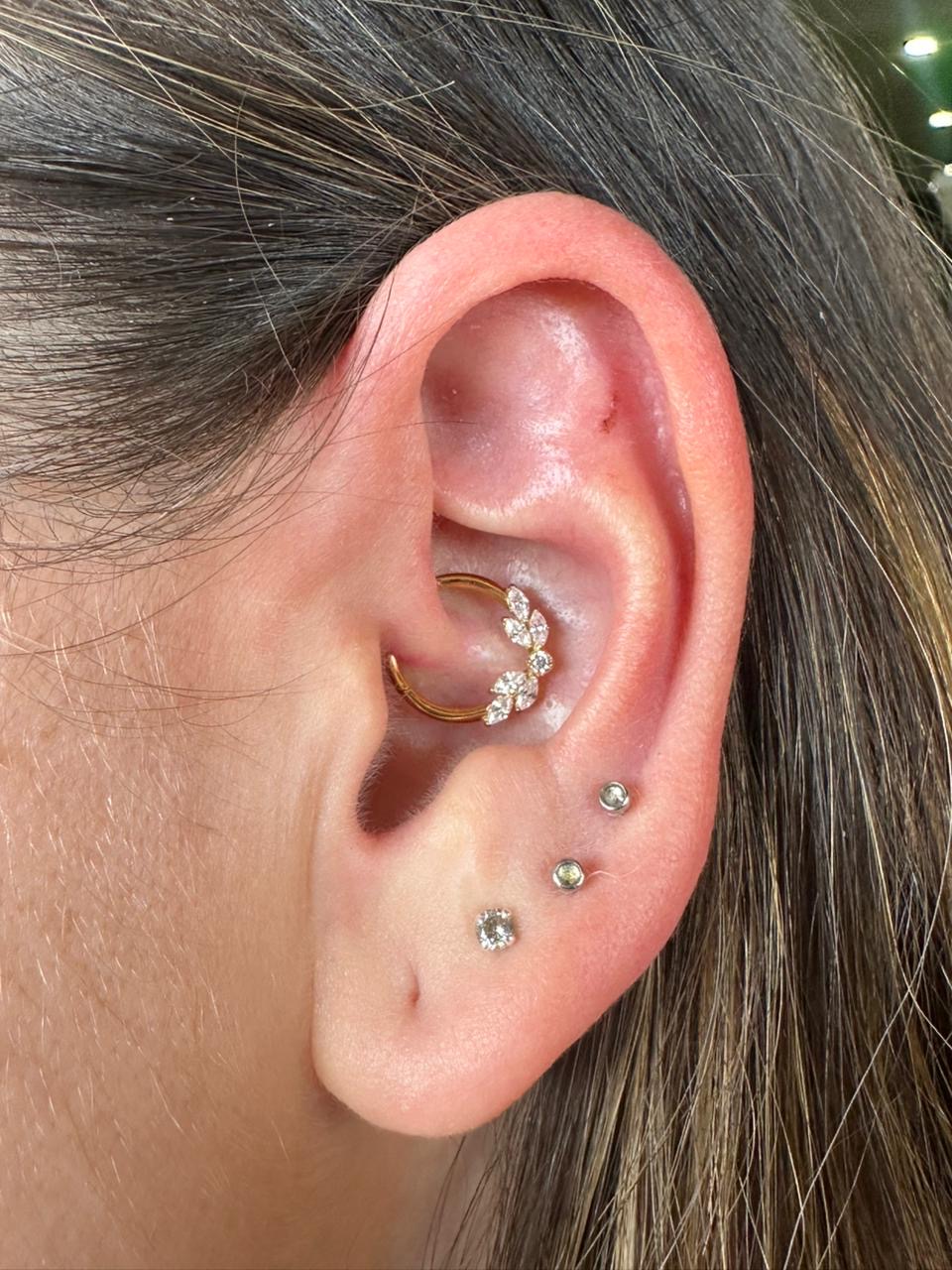 Healed daith and lobe piercings with gold flower jewellery by Ray